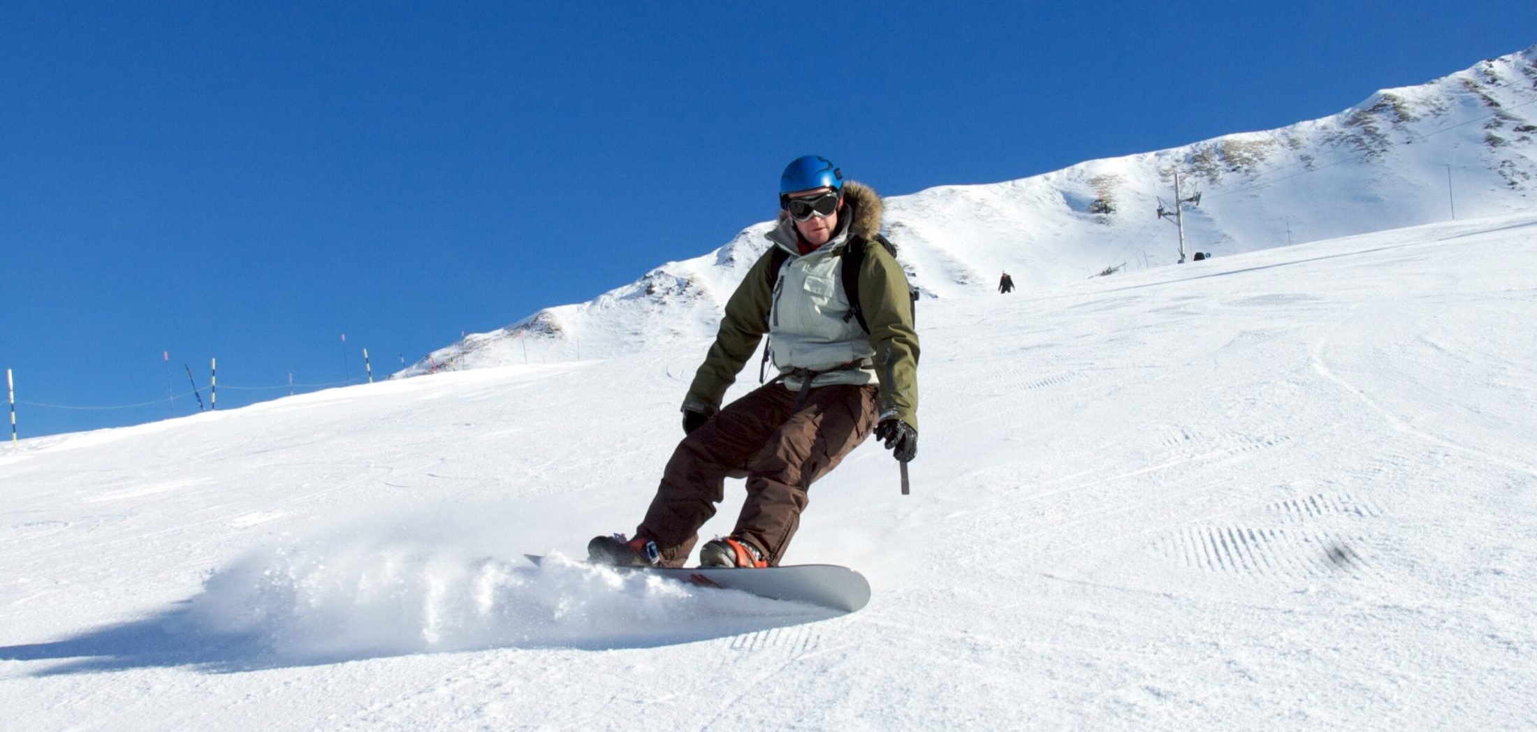 Mike Jones snowboarding down a mountain slope