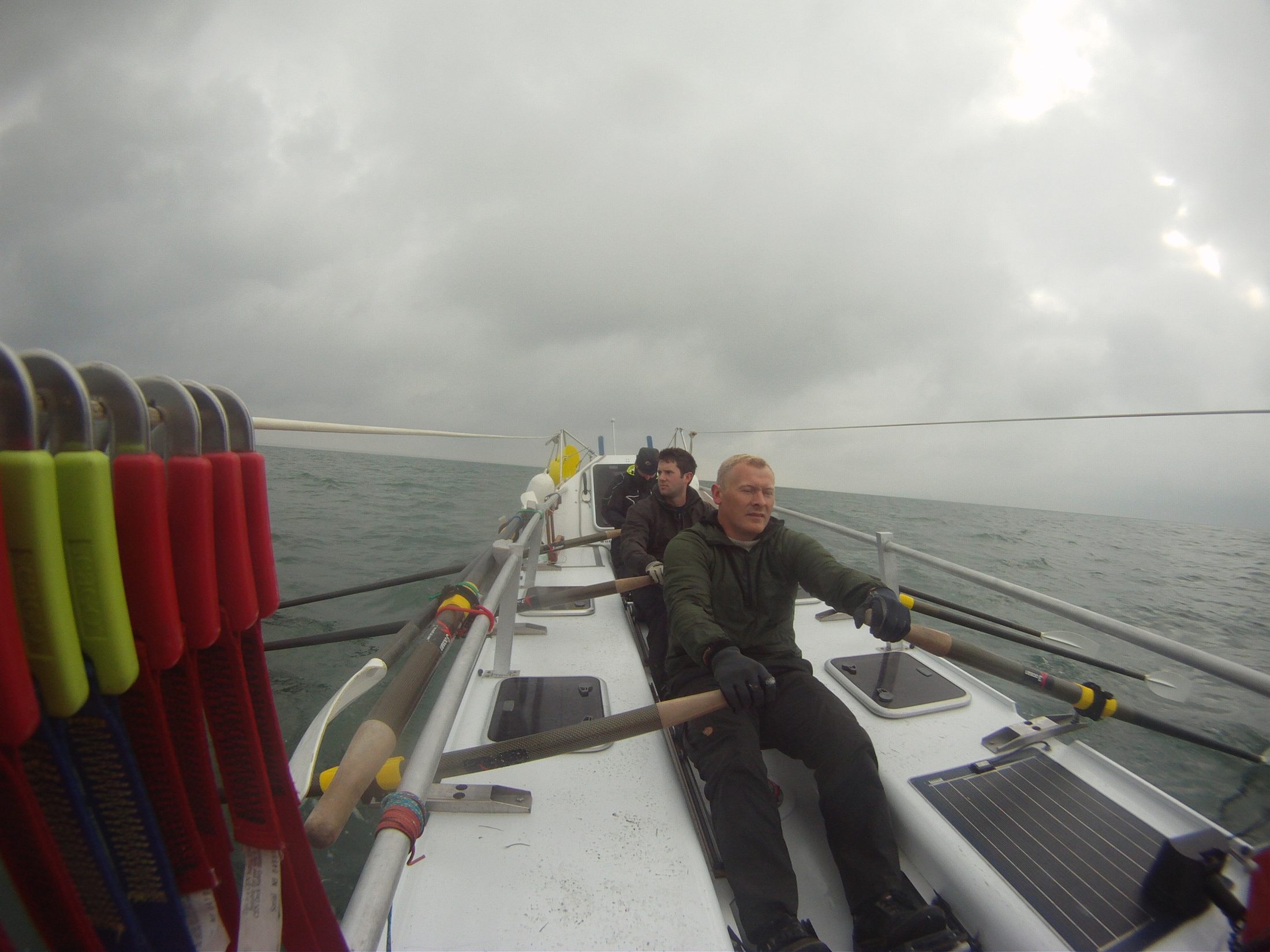 The crew rowing together through rough weather during the Atlantic crossing